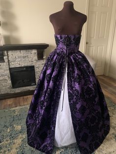 Finally! I have so many requests for this easy-to-wear, mix and match, functional corset, with attached over skirt! This is a striking royal purple, red, royal blue, or white taffeta flocked with a black damask design throughout. This fabric has a great body to it that doesn't require an underskirt for fullness, but will definitely look great over a hoop, or another underskirt. (white under-slip not included) The waist cincher has 9 sewn in bones and is double boned along the front closure of 10 Fitted Purple Dress With Corset Back, Fitted Gothic Ball Gown, Fitted Purple Dress With Long Train, Purple Fitted Dress With Long Train, Fitted Purple Overbust Dress, Gothic Ball Gown With Fitted Bodice, Satin Dress With Attached Cancan For Costume Party, Elegant Purple Corset Dress With Corset Back, Fitted Gown With Corset Back And Overbust