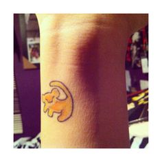 a small wrist tattoo with an elephant on it