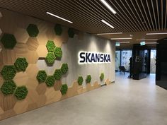 the entrance to skaanska's office is decorated with greenery and letters