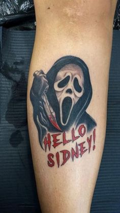 a person with a tattoo on their leg that says hello spidery and a ghost holding a knife