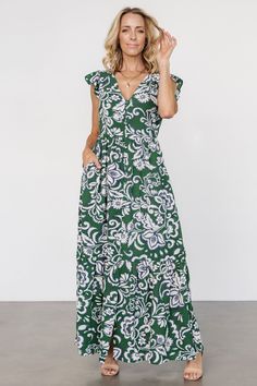 Beautiful flowy dress for warm days Lightweight Georgette material Green background with Cream and Navy Blue botanical print Fit runs big, we recommend sizing down V-neckline Cap style flutter sleeve Functional buttons down front of dress, end at bottom tier Subtle gathering at waist Hidden side pockets Single bottom tier Lined bodice, skirt lined to the tier Self: 98% Polyester, 2% Spandex Lining: 97% Polyester, 3% Spandex Trina is 5'6, cup size 32D, size 2 and is wearing size XS Georgette Material, Button Maxi Dress, Baltic Born, Cap Style, Maxi Dress Black, Maxi Dress Green, Green Print, Botanical Print, Flowy Dress