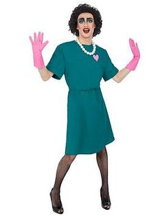 a woman in a green dress and pink gloves is standing with her hands out to the side