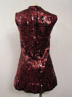 "Vintage 1960s mini dress with black and red sequins. Geometric design. Sleeveless. Neru collar, back zipper and Satin lining. Made by Winkleman's. Size small/medium. Actual measurements are: 33\" around the bust 31\" around the waist 33\" around the hips 14\" shoulder to shoulder 30\" overall length In excellent condition." Dress Black And Red, Black And Red Dress, 1960s Mini Dress, Vintage Mini Dress, Vintage Mini Dresses, 1960s Dress, Dress Sequin, 1960's Dress, Dress Designer