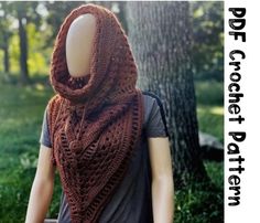 a woman wearing a brown knitted shawl in front of a tree with the words free crochet pattern on it