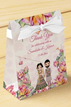 a wedding gift bag with an image of two people on it and the words, thank you for celebrating with us