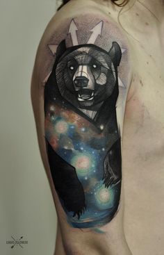 a man's arm with a bear and stars tattoo on the upper half of his arm