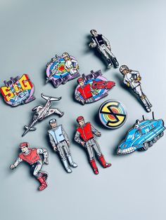 several pin badges are shown on a gray surface