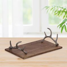 a wooden tray with antlers on it