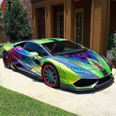 a multicolored sports car parked in front of a house