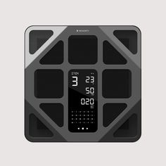 a digital clock is displayed on a gray and black surface, with the time at 11 30