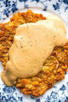 a plate with some kind of food covered in gravy on top of it