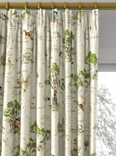 the curtains in this room are drawn with animals and trees on them, along with other things