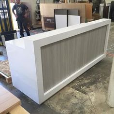 a man standing next to a counter in a warehouse