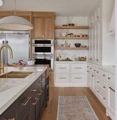 a kitchen with wooden cabinets and white countertops is pictured in this image from the front view