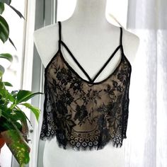 Black Lace Criss Cross Strappy Lined Flowy Crop Camisole Top Size Xs New Without Tags, Never Worn. Take Your Weekend Look To The Next Level, In This Sultry Lace Camisole Top. Featuring A Black Lace Material With A Beige Inner Lining, Cross Over Strap Detail And A Lace Hem. Team This Crop With Your No.1 Denim Jeans And Fave Heels. Materials: 100% Polyester Offers Welcome! Ships Same Or Next Day! Black Lace Tank Top With Straps, Black Lace Cami Crop Top, Black Sleeveless Lace Crop Top, Spring Bra-friendly Black Tank Top, Spring Bra Friendly Black Tank Top, Gold Sequin Crop Top, Black Crochet Crop Top, Cross Crop Top, Sparkly Crop Tops