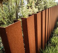 a close up of a metal fence in the grass