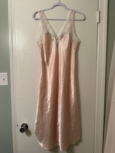 This is such a pretty feminine nightgown! You will be so beautiful in this one! It's soft and silky, the lace and the flower details add such a girly touch to it!  It's just gorgeous!  There is one teeny tiny mark, looks like a pen mark, see picture, you can barely notice it! Pink Lace Nightgown For Sleepovers, Feminine Pink Slip Dress For Sleepover, Pink Lace Camisole Nightgown, Bedtime Lace Slip Dress With Lace Trim, Cream Sleeveless Sleepwear With Lace Trim, Pink Delicate Lace Nightgown For Sleep, Pink Delicate Lace Nightgown, Pink Lace Nightgown For Sleep, Pink Lace Slip Dress For Sleep