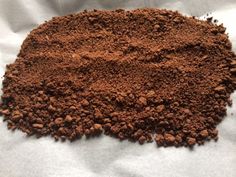 a pile of brown powder on top of a white sheet