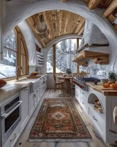 an oval shaped kitchen with wood floors and white cabinets, along with a rug on the floor