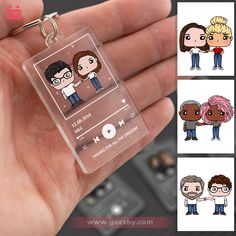 a person holding a clear keychain with various avatars on the front and back