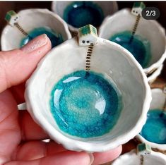 a hand holding a white and blue ceramic bowl