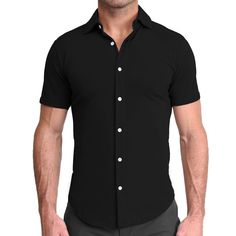 A true athletic fit short sleeve button down crafted from a cotton-spandex blend, this black short sleeve is as soft and stretchy as it gets. "The Roth" is the most versatile button down for in all seasons, featuring shortened length and a curved hemline, leaving you looking and feeling fresh for both casual wear and a great night out. Care: Machine wash cold. Hang to dry. Fabric: 90.5% Cotton / 9.5% Spandex Model is 6' and 185 lbs. filling out size Medium. SIZING Our shirts are designed for a " Fitted Short Sleeve Black Shirt With Buttons, Fitted Black Button-up Short Sleeve Shirt, Fitted Black Short Sleeve Button-up Shirt, Fitted Short Sleeve Cotton Shirt, Fitted Plain Cotton Short Sleeve Shirt, Classic Black Shirt With Snap Buttons, Classic Fitted Black Short Sleeve Shirt, Classic Black Short Sleeve Shirt, Black Cotton Button-up Short Sleeve Shirt