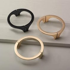 three different types of rings sitting on top of a white counter next to each other