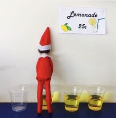 an elf is standing in front of lemonade cups