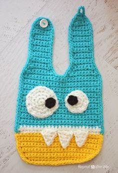 a crocheted bag with eyes and mouth