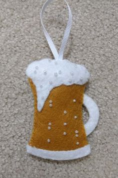 an ornament made to look like a beer mug on the floor with white trim