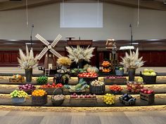 an arrangement of fruits and vegetables on display in a church