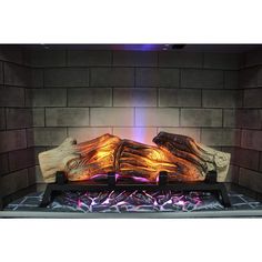 a fireplace that has some kind of wood on it with flames coming out of it