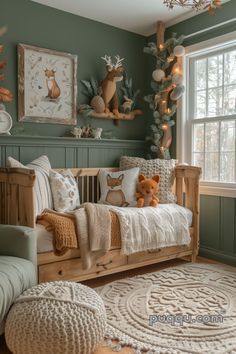 a baby's room with green walls and wooden furniture