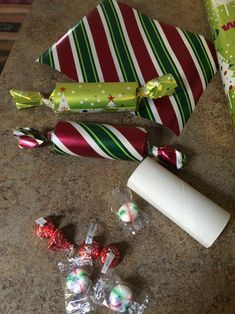 candy and wrapped presents on a counter top with wrapping paper, peppermint sticks, and christmas candies