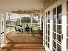 an outdoor covered porch with tables and chairs