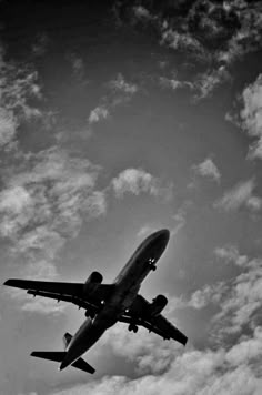 an airplane is flying in the sky on a clear day with some clouds behind it