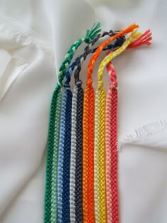 there are four different colors of thread on the white shirt, and one is multicolored