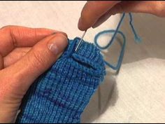 someone is knitting something with blue yarn