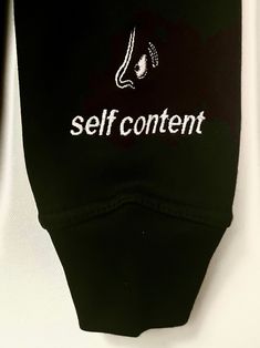 Heavy, black 100% cotton hoodie with white embroidery. Back panel: “For Me” in the center with page 2 indicated at the bottom. Left arm: “Self Content” across left wrist, with A Shot in the Dark logo above. Fit: Slim fitting body, recommend to size up one size for natural fit, two sizes for oversized fit | Model is wearing size small Care Instructions: Machine wash cold or dry clean Black Cotton Hoodie With Embroidered Logo, Dark Logo, Shot In The Dark, Hoodie Xxl, Idea Board, White Embroidery, Cotton Hoodie, In The Dark, Fitness Models