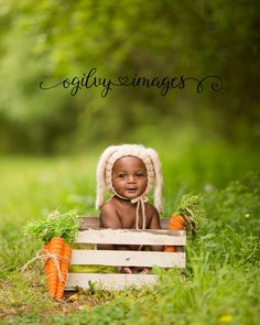 a baby is sitting in a crate with carrots on it and the caption says godly images