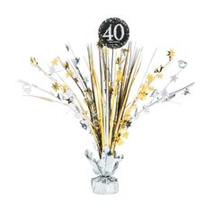 a clear vase filled with lots of gold and silver stars next to a number 40 sign