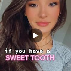 a woman with long brown hair wearing a gray t - shirt and pink lettering that says, if you have a sweet tooth