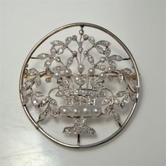 Here we have an antique Art Nouveau pin crafted in platinum and 18K yellow gold and set with rose cut diamonds and natural sea pearls circa 1900. This piece is likely to have hailed from Germany with stylistic motifs consistent with jugendstil which literally translates to youth style being the German equivalent to the Art Nouveau style in France and Europe. The piece is extraordinarily feminine, appearing like lace. The old cut diamonds sparkling beautifully. Across the front of this ethereal j Luxury Diamond White Brooches For Wedding, Wedding Yellow Gold Filigree Brooches, Ornate Yellow Gold Wedding Brooch, Yellow Gold Filigree Brooches For Wedding, Heirloom Wedding Brooches With Intricate Design, Wedding Diamond Brooch With Intricate Design, Elegant Yellow Gold Wedding Brooches, Ornate Diamond Brooches For Anniversary, White Gold Wedding Brooches With Intricate Design