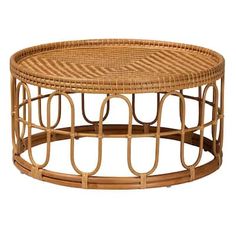 a round wicker coffee table with metal rings on the top and bottom, sitting against a white background