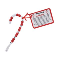 a red and white beaded lanyard with a tag attached to it