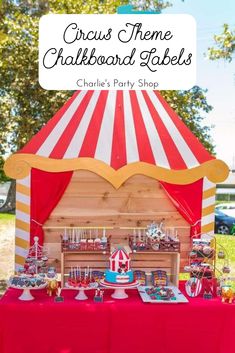 a circus themed birthday party table with red and white striped tent, cupcakes and candy bar