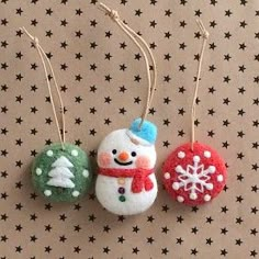 three ornaments are hanging on the wall