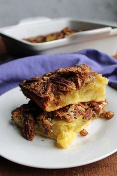 two pieces of pecan pie on a white plate