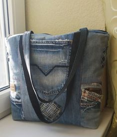 Upcycled denim, distressed denim bag, big jeans tote bag, denim zippered shopper, handmade denim laptop carrying case, denim shoulder bag. This denim bag was made from upcycled distressed jeans. It is rather big and roomy. It can be used as a tote bag, a shopper, a laptop carrying case. The bas has four outside pockets and a pocket inside. It is lined with a cotton fabric.  It can make a perfect present for a person who likes jeans and denim fabric.  This shoulder denim bag will be usefull and functional in everyday life. It can be washed if necessary.   The size is 40 cm x 35cm x 6 cm. bottom (16 x14 x 2.5 in. bottom)   This very bag was made to order. I will make a similar one for you.  Please mind that it can be a bit different as it depends on the jeans upcycled. Thank you for visiting Handmade Denim Tote Shoulder Bag, Everyday Distressed Tote Bag, Blue Cotton Jeans For Everyday Use, Casual Handmade Recycled Denim Shoulder Bag, Everyday Handmade Recycled Denim Bag, Casual Handmade Shoulder Bag In Recycled Denim, Handmade Everyday Bag In Recycled Denim, Distressed Denim Blue Bag For Everyday Use, Handmade Everyday Bags From Recycled Denim