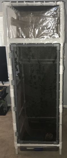 the back side of a computer case wrapped in plastic and sitting on top of a carpeted floor